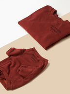 flatlay of human and dog maroon terry pullovers on white and tan backdrop